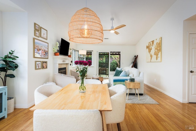 dining room with light hardwood / wood-style floors, lofted ceiling, and ceiling fan