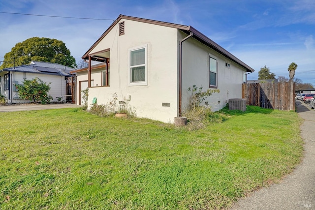 view of side of property with a yard and central air condition unit