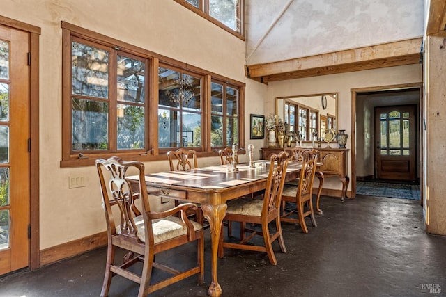 dining room with a towering ceiling