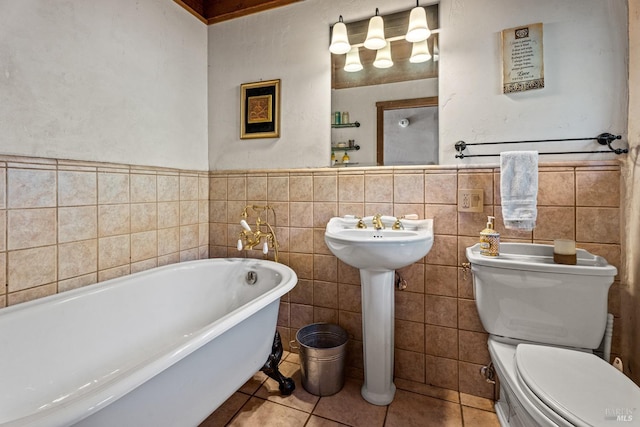 bathroom with tile patterned flooring, sink, tile walls, toilet, and a washtub