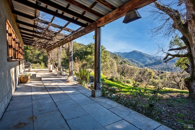 view of patio / terrace featuring a mountain view