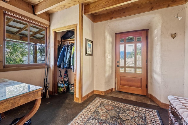 entryway featuring plenty of natural light, beam ceiling, and wood ceiling