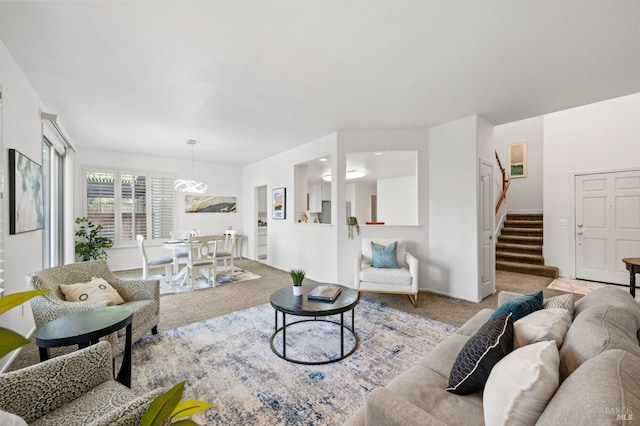 living room featuring stairway and carpet flooring