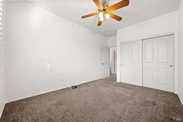 unfurnished bedroom with ceiling fan, a closet, and carpet