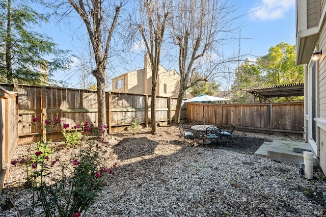 view of yard with a fenced backyard, a pergola, and a patio