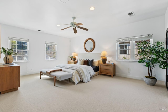 bedroom featuring light carpet, visible vents, and recessed lighting