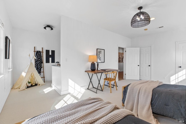 carpeted bedroom featuring visible vents and baseboards