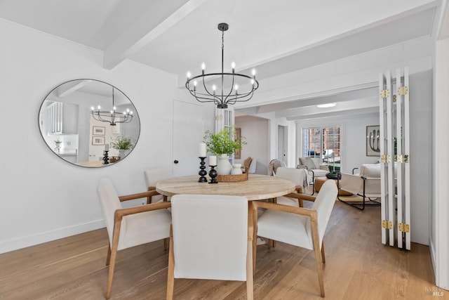 dining space featuring beamed ceiling, light wood-style floors, and a chandelier