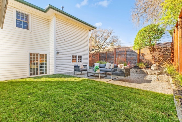 back of house with a fenced backyard, an outdoor hangout area, a lawn, and a patio