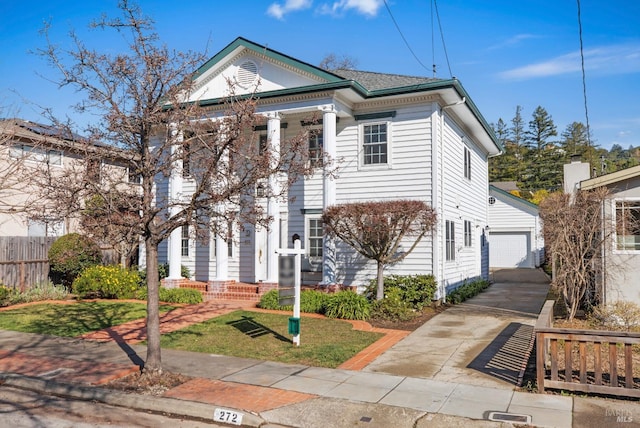 greek revival house featuring an outdoor structure and fence