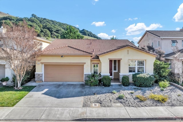 view of front of house with a mountain view and a garage