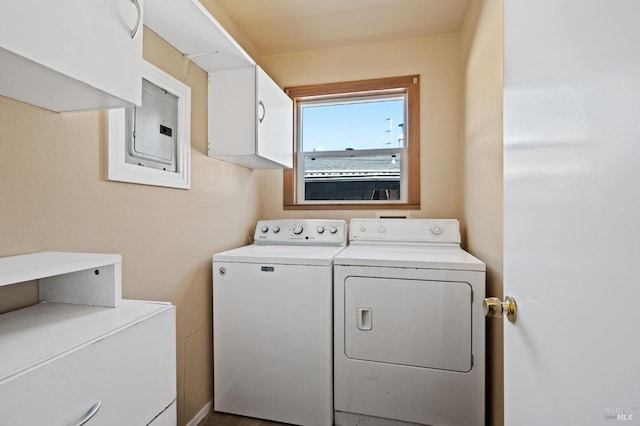 laundry area with electric panel, cabinet space, and washer and clothes dryer