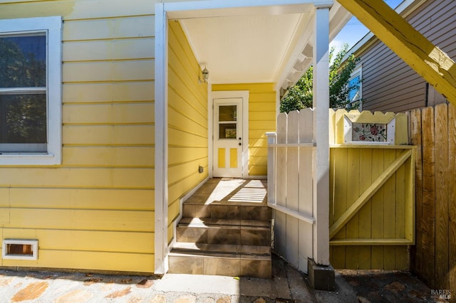 entrance to property featuring fence