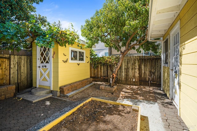 exterior space featuring an outbuilding, a storage unit, and a fenced backyard