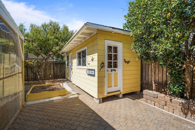 view of outbuilding featuring an outbuilding, a vegetable garden, and a fenced backyard