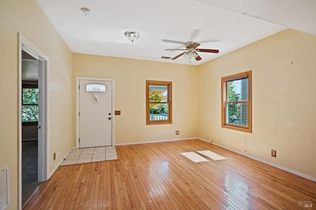 entrance foyer with visible vents, baseboards, light wood finished floors, and ceiling fan