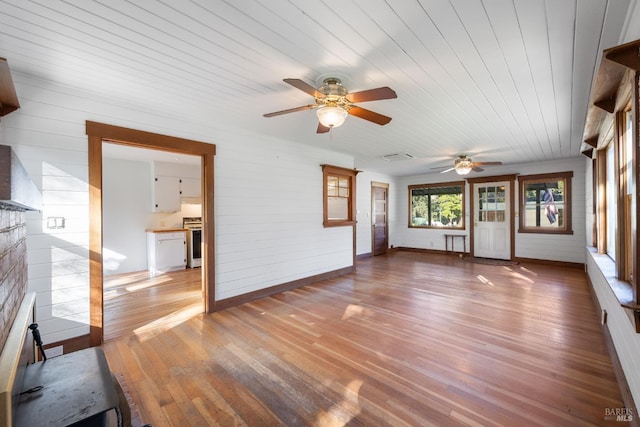 unfurnished living room with wood ceiling and wood-type flooring