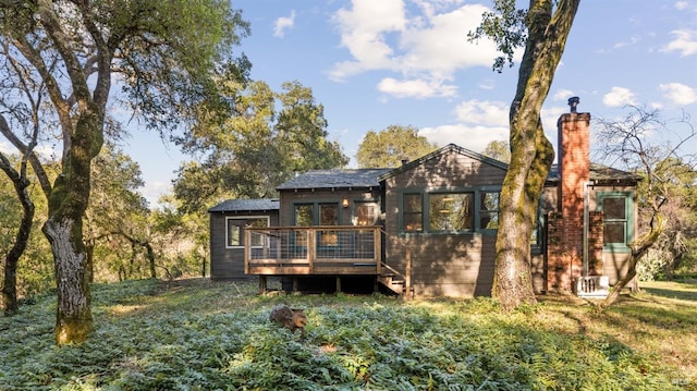 rear view of property with a wooden deck