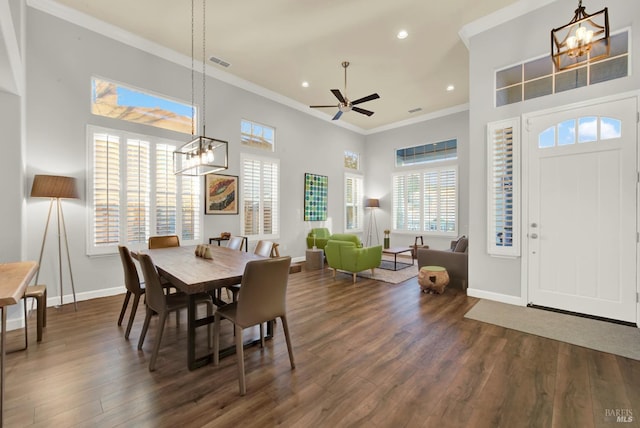 dining room featuring ornamental molding, dark hardwood / wood-style floors, and ceiling fan with notable chandelier