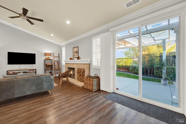 living room featuring hardwood / wood-style flooring, a healthy amount of sunlight, and ornamental molding