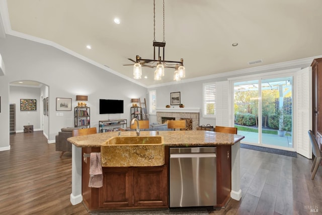 kitchen featuring pendant lighting, dishwasher, sink, ornamental molding, and a kitchen island with sink