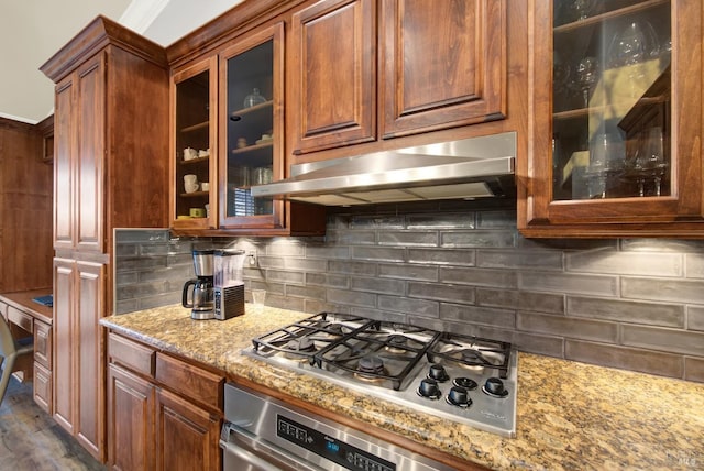 kitchen featuring dark hardwood / wood-style flooring, light stone countertops, decorative backsplash, and stainless steel appliances