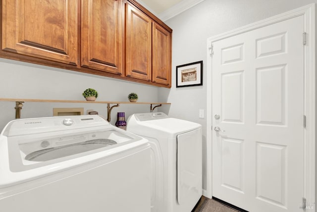 washroom featuring cabinets, ornamental molding, and washer and clothes dryer