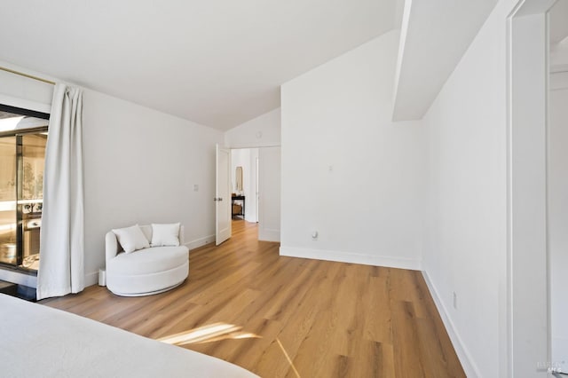 living area with lofted ceiling and light wood-type flooring