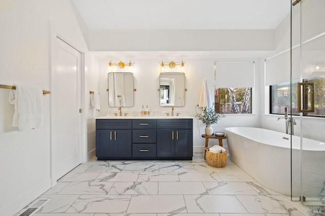 bathroom with vanity and a washtub