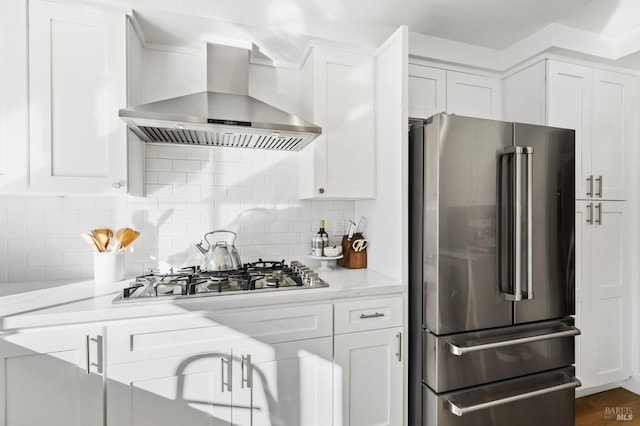 kitchen with extractor fan, white cabinets, and appliances with stainless steel finishes