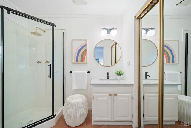 bathroom featuring vanity, walk in shower, tile patterned floors, and ornamental molding