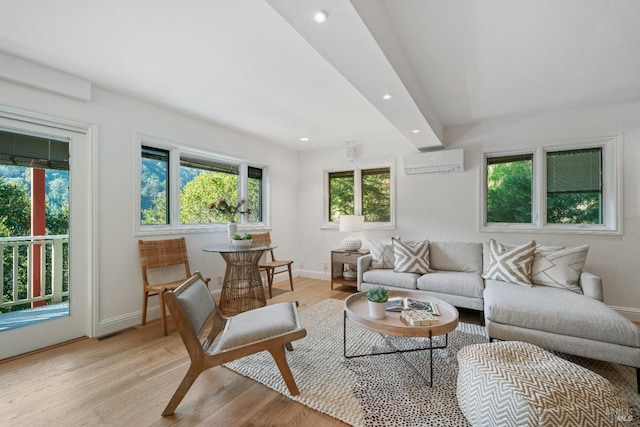 living room featuring a wall mounted AC and light hardwood / wood-style floors