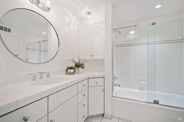 bathroom with shower / bath combination with glass door, tile patterned floors, and vanity