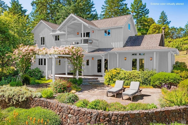 back of house featuring a balcony and a patio area