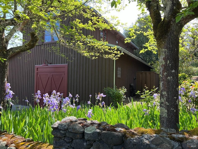 view of home's exterior with an outdoor structure