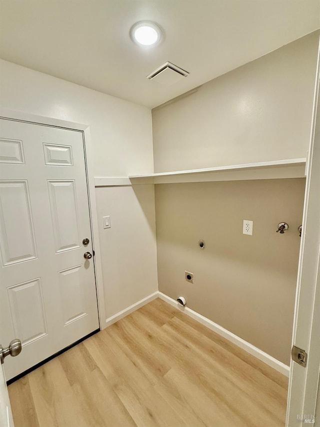 washroom featuring electric dryer hookup and light hardwood / wood-style floors