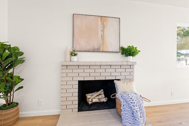 interior details with a brick fireplace and hardwood / wood-style floors