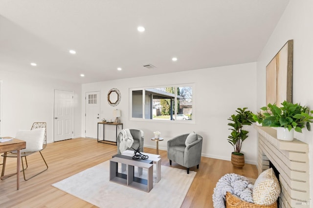 living room with a fireplace and light hardwood / wood-style floors