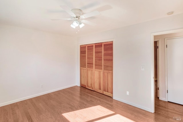 unfurnished bedroom featuring light wood-type flooring, a closet, and ceiling fan