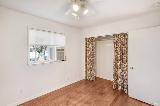 unfurnished bedroom with light hardwood / wood-style flooring, a closet, and ceiling fan