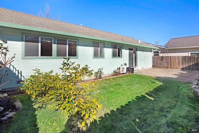 back of property with a patio area and a lawn