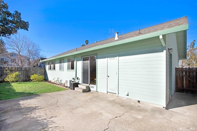 back of house with a patio and a yard