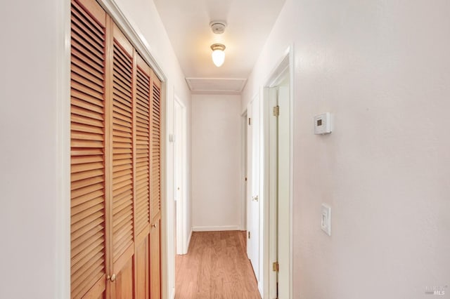 corridor with light hardwood / wood-style floors