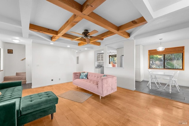 living room with coffered ceiling, light hardwood / wood-style floors, and beam ceiling