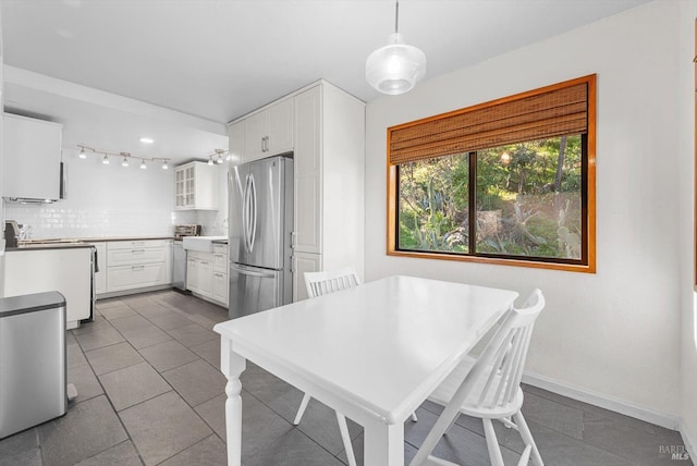 dining space featuring dark tile patterned flooring