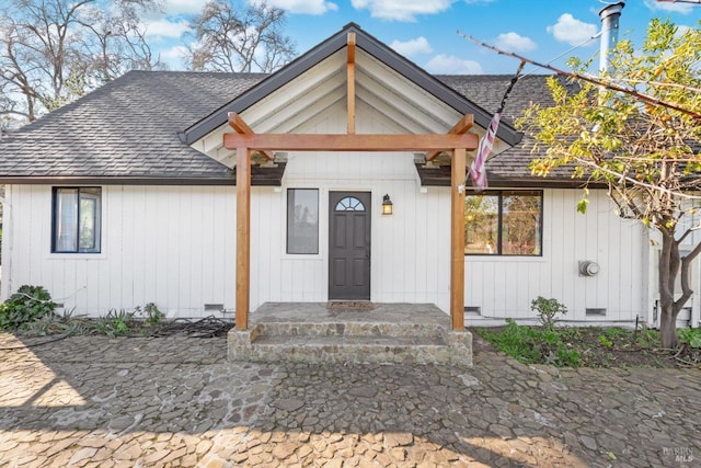 view of front of house with crawl space and a shingled roof