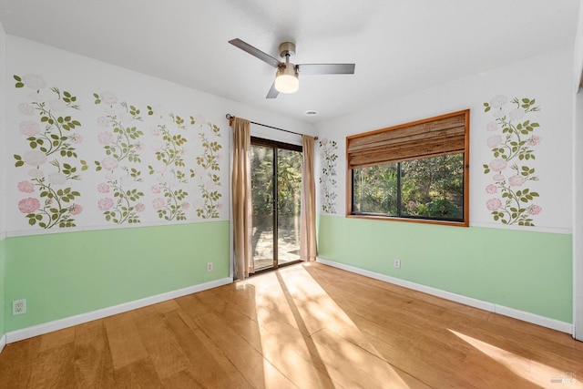 spare room featuring hardwood / wood-style floors and ceiling fan