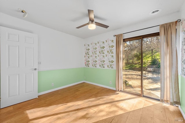 spare room featuring wood-type flooring and ceiling fan