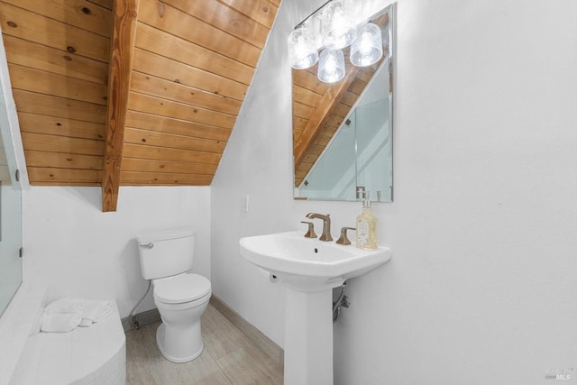 bathroom featuring wood ceiling, sink, toilet, and lofted ceiling with beams