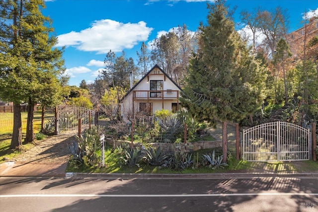 english style home featuring fence and a gate
